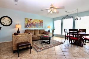 a living room with a couch and a dining room at Waterwheel Retreat in New Braunfels