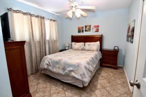 a bedroom with a bed and a ceiling fan at Waterwheel Retreat in New Braunfels +14 photos