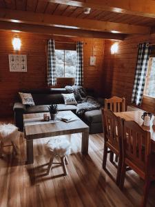 a living room with a couch and a table at Domki u Basi in Kudowa-Zdrój