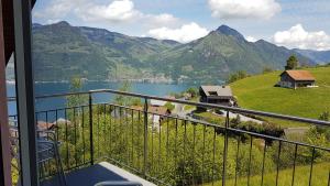 a balcony with a view of a lake and mountains at BellaRosa in Emmetten