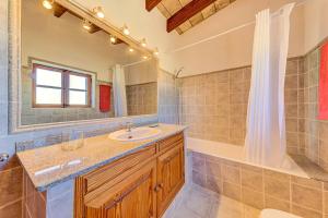 a bathroom with a sink and a tub and a mirror at Can Seguinot Mercer by Sealand Villas in El Port +15 photos