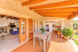 a patio with a table and chairs and a living room at Can Seguinot Mercer by Sealand Villas in El Port