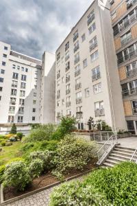 an apartment building with stairs in front of it at JessApart– Babka Tower Apartment in Warsaw