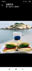 two sandwiches on a plate on a table at 芹壁溫馨海景民宿 in Beigan