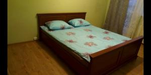 a bed with two pillows on it in a bedroom at Уютная квартира рядом с метpo Холодная гора in Kharkiv