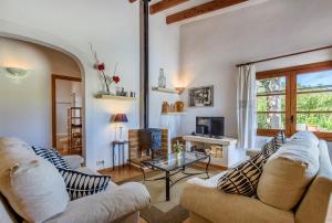 a living room with two couches and a tv at Villa Fullos by Sealand Villas in Pollença