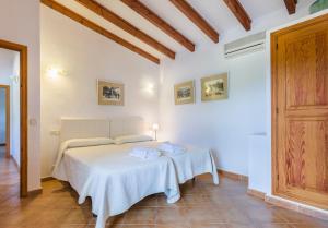 a white room with a bed with two towels on it at Villa Fullos by Sealand Villas in Pollença +16 photos
