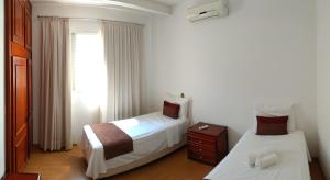 Postel nebo postele na pokoji v ubytování Hotel dos Lagos