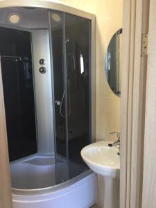 a bathroom with a shower and a sink at Villa Bossa in Zatoka