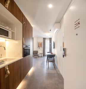 a kitchen with a refrigerator, stove, sink, and dishwasher at Lisbon Serviced Apartments - Avenida in Lisbon