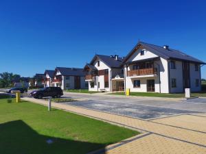 a group of houses on a street with a car at goodapartments in Nałęczów