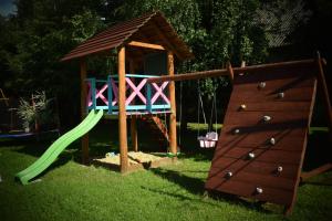 a playground with a slide and a play structure at Bieszczadzka Świteź in Baligród