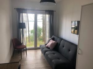 a living room with a couch and a window at Powidz pokoje z widokiem na jezioro in Powidz