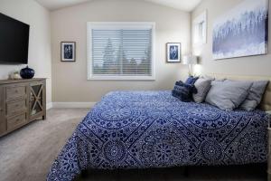 a bedroom with a bed and a television and a window at Milwuakie Heights South Villa in Oak Grove
