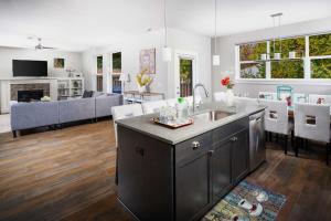 a kitchen and living room with a couch and a table at Alexander Villa in Aloha