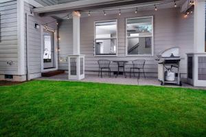 a patio with a grill and a table and chairs at Alexander Villa in Aloha