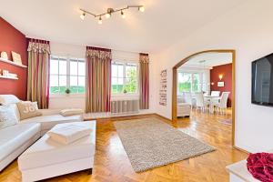 a living room with a white couch and a mirror at Ferienwohnung Panoramablick Freudenstadt in Freudenstadt