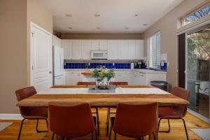 a kitchen with a large wooden table and chairs at Beaverton Creek Cottage in Beaverton