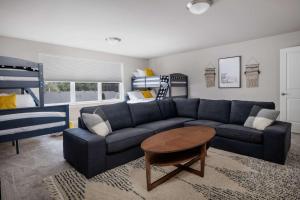 a living room with a blue couch and a table at Whispering Woods in Aloha
