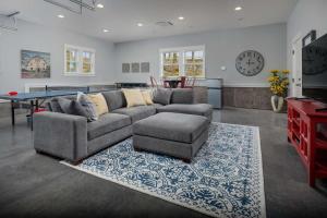 a living room with a couch and a ping pong table at The Farmhouse at Quandary Vineyards in Carlton