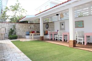 a patio with a table and chairs on it at Villamer Alaçatı in Alaçatı