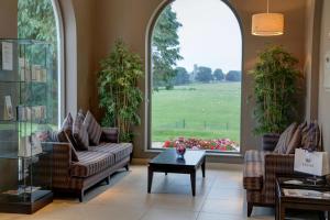 a living room with two couches and a table at Best Western Lamphey Court Hotel and Spa in Lamphey