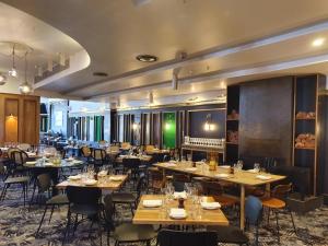 a restaurant with tables and chairs in a room at Middle Park Hotel in Melbourne