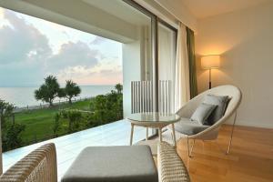 a living room with a view of the ocean at Beach Hotel Sunshine in Ishigaki Island