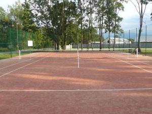 a tennis court with two people on it at Wellness Villa Liptov in Liptovská Sielnica