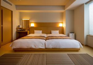 Ένα ή περισσότερα κρεβάτια σε δωμάτιο στο Hotel Monterey Fukuoka