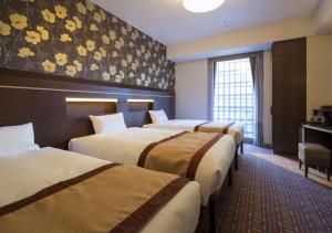 Ένα ή περισσότερα κρεβάτια σε δωμάτιο στο Hotel Monterey Fukuoka
