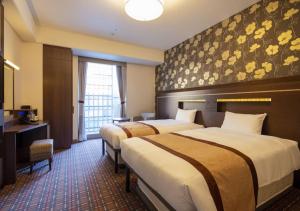 Ένα ή περισσότερα κρεβάτια σε δωμάτιο στο Hotel Monterey Fukuoka