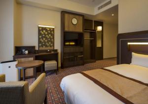 Ένα ή περισσότερα κρεβάτια σε δωμάτιο στο Hotel Monterey Fukuoka