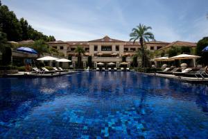a large swimming pool in front of a building at Hangzhou Rose Garden Resort & Spa in Hangzhou
