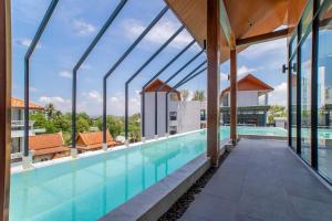 a swimming pool with a view of a building at 2BDR Apartment near Surin beach #703 in Surin Beach