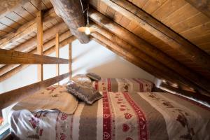 a bedroom with two beds in an attic at Baita Mirellina - Case di Viso in Ponte di Legno