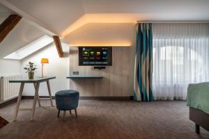 TV a/nebo společenská místnost v ubytování Holiday Inn - the niu, Rig Lübeck by IHG