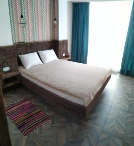 a bedroom with a large bed with blue curtains at Апарт-Отель - 12 шагов к морю, ЖК Орион in Odesa