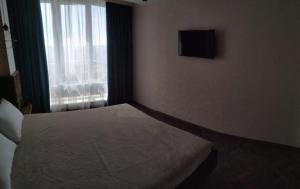 a hotel room with a bed and a window at Апарт-Отель - 12 шагов к морю, ЖК Орион in Odesa