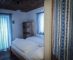 a bedroom with two beds and two windows at Speiereckhütte in Mauterndorf +14 photos