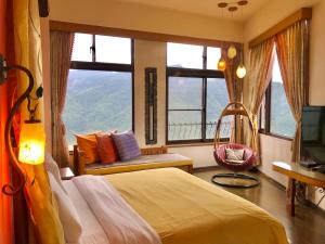 a bedroom with a bed and a tv and windows at Margaret Garden Villa in Ren'ai