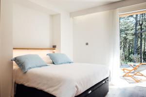 Ένα ή περισσότερα κρεβάτια σε δωμάτιο στο Le Lodge