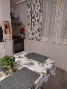 a small kitchen with a table and a window at Sweet Home in Burgas