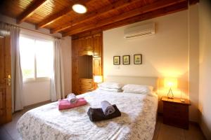 a bedroom with a large bed with two towels on it at Hilltop Chalet in Pissouri +18 photos
