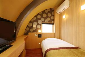 En eller flere senger på et rom på Hotel Matsunoi