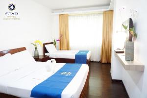 Postel nebo postele na pokoji v ubytování Star Hotel