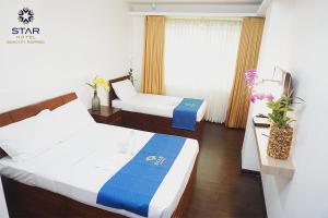 Postel nebo postele na pokoji v ubytování Star Hotel