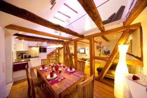 a kitchen and dining room with a wooden table in a room at Ferienhaus - die710 in Rothenburg ob der Tauber