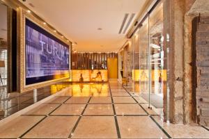 a hallway with a large screen in a building at TURIM Terreiro do Paço Hotel in Lisbon