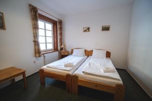Postel nebo postele na pokoji v ubytování Hotel Večernice